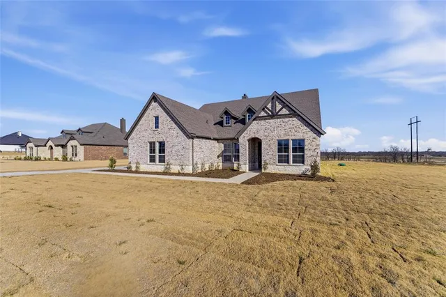 a view of house with yard and ocean view