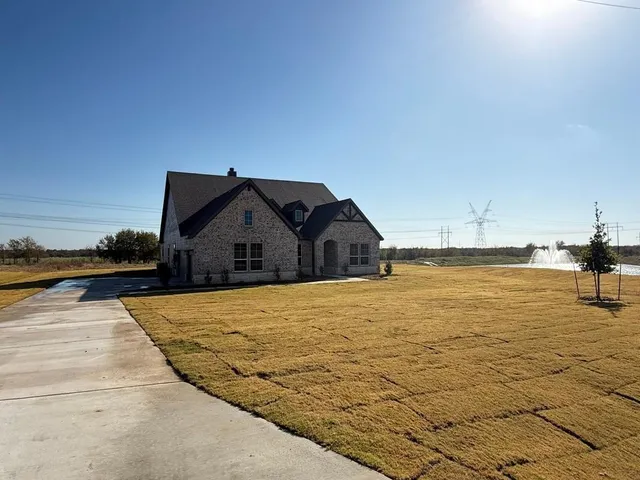 a view of a hallway with wooden floor and closet