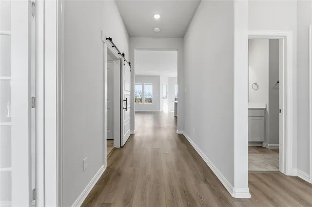 a view of hallway with wooden floor