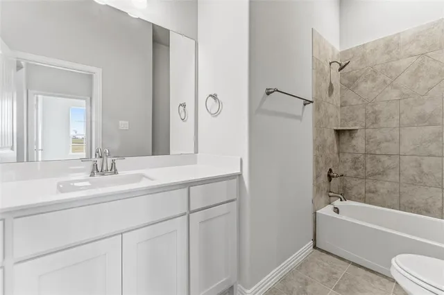 a bathroom with a bathtub shower sink vanity and a toilet