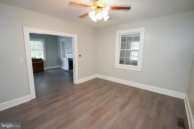 wooden floor in an empty room with a window