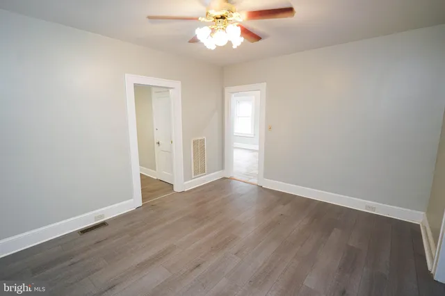 an empty room with wooden floor and closet