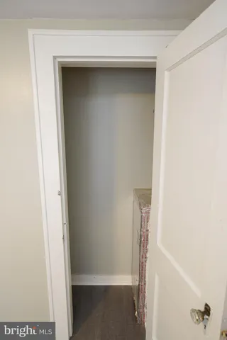 a view of a hallway with staircase and white walls