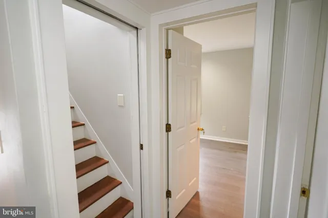 an empty room with wooden floor and a window