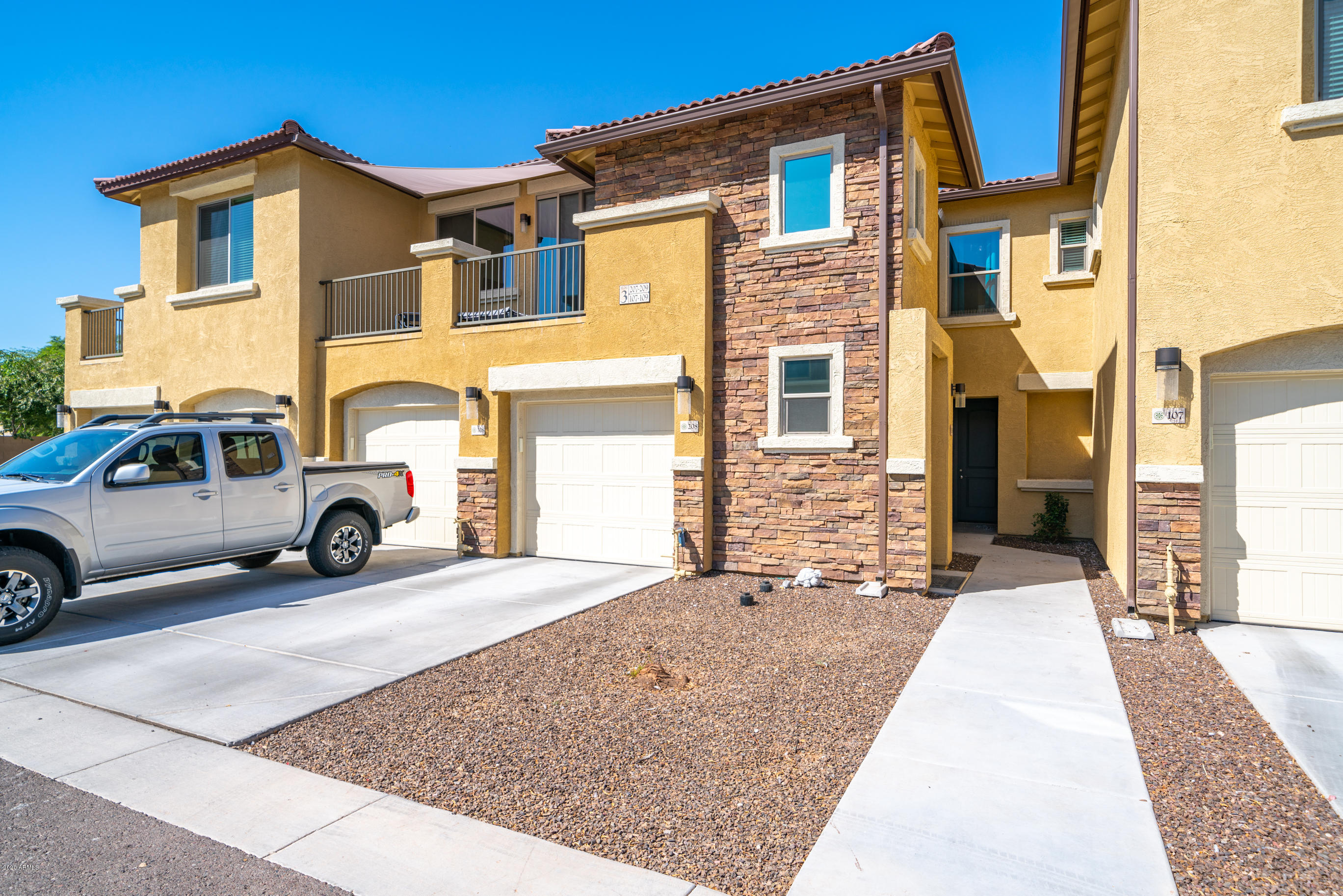 7820 East Baseline Road, Unit 208 Mesa, AZ 85209 - Photo 1 of 29 a view of a car park in front of a house