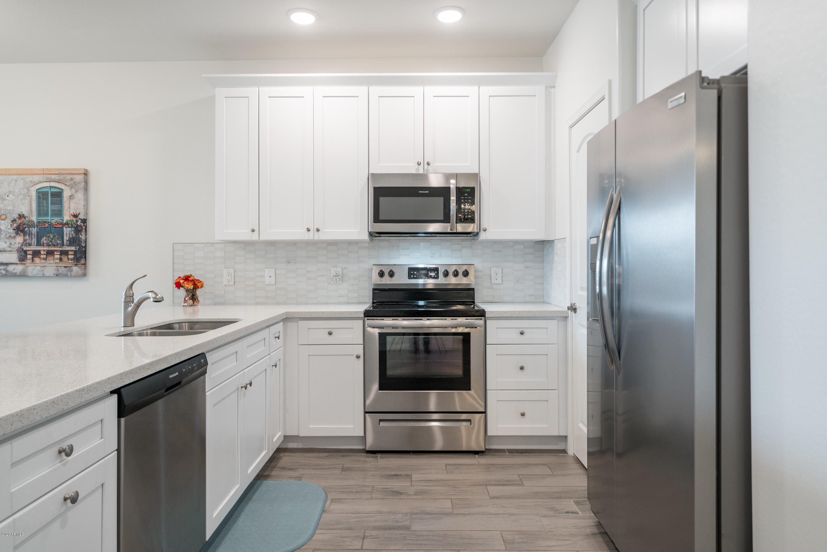 7820 East Baseline Road, Unit 208 Mesa, AZ 85209 - Photo 13 of 29 a kitchen with white cabinets and stainless steel appliances