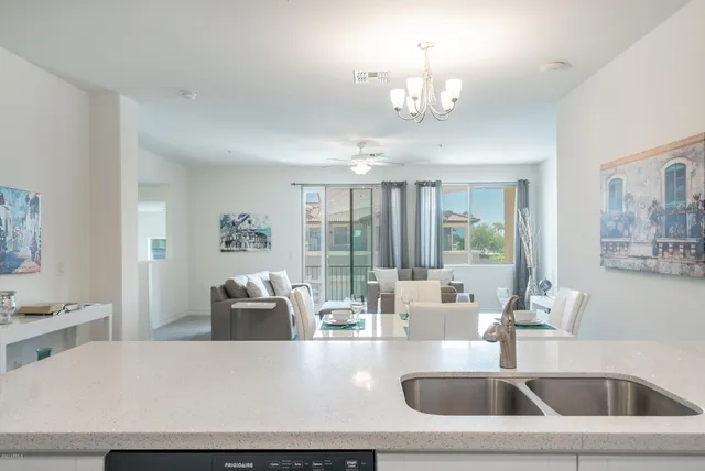 a kitchen with a sink and a large mirror