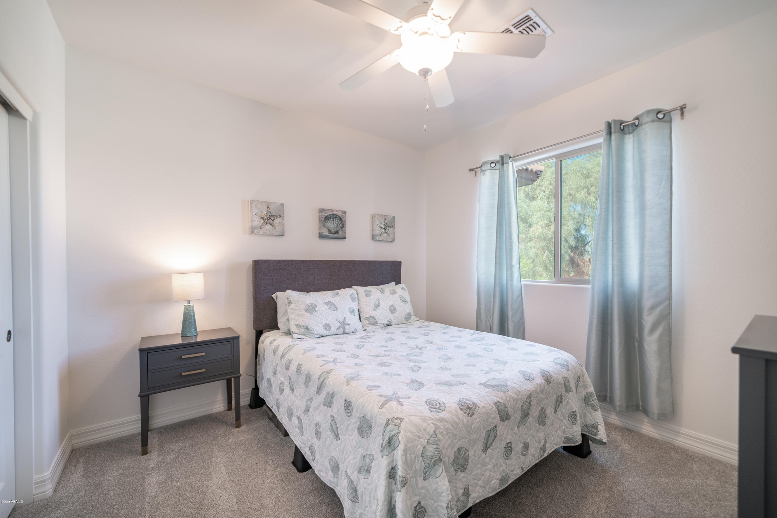 7820 East Baseline Road, Unit 208 Mesa, AZ 85209 - Photo 17 of 29 a bedroom with a bed and a chandelier