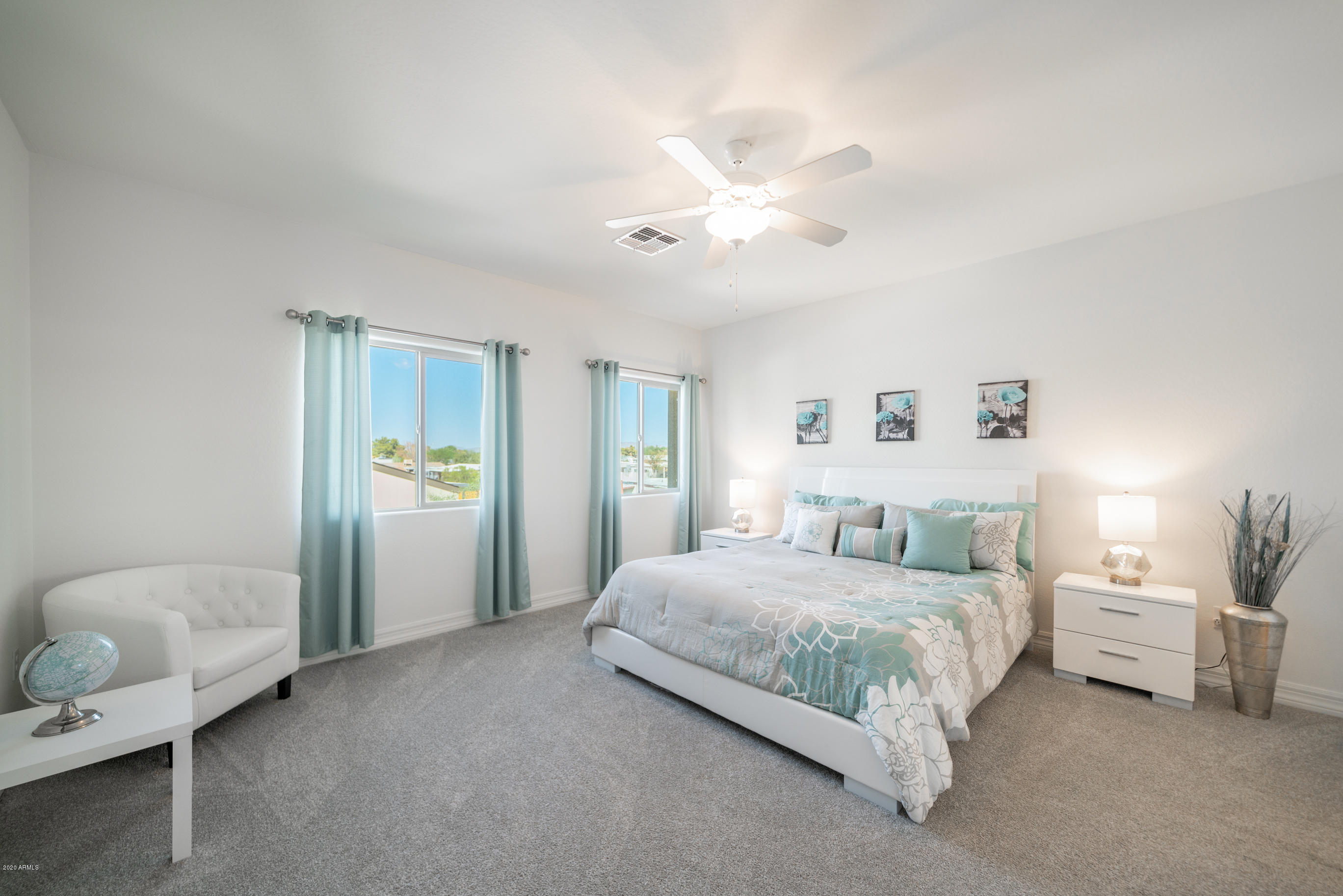 7820 East Baseline Road, Unit 208 Mesa, AZ 85209 - Photo 18 of 29 a bedroom with a bed and a chandelier