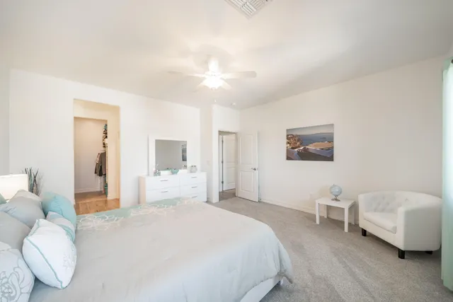 a spacious bedroom with a bed and a couch