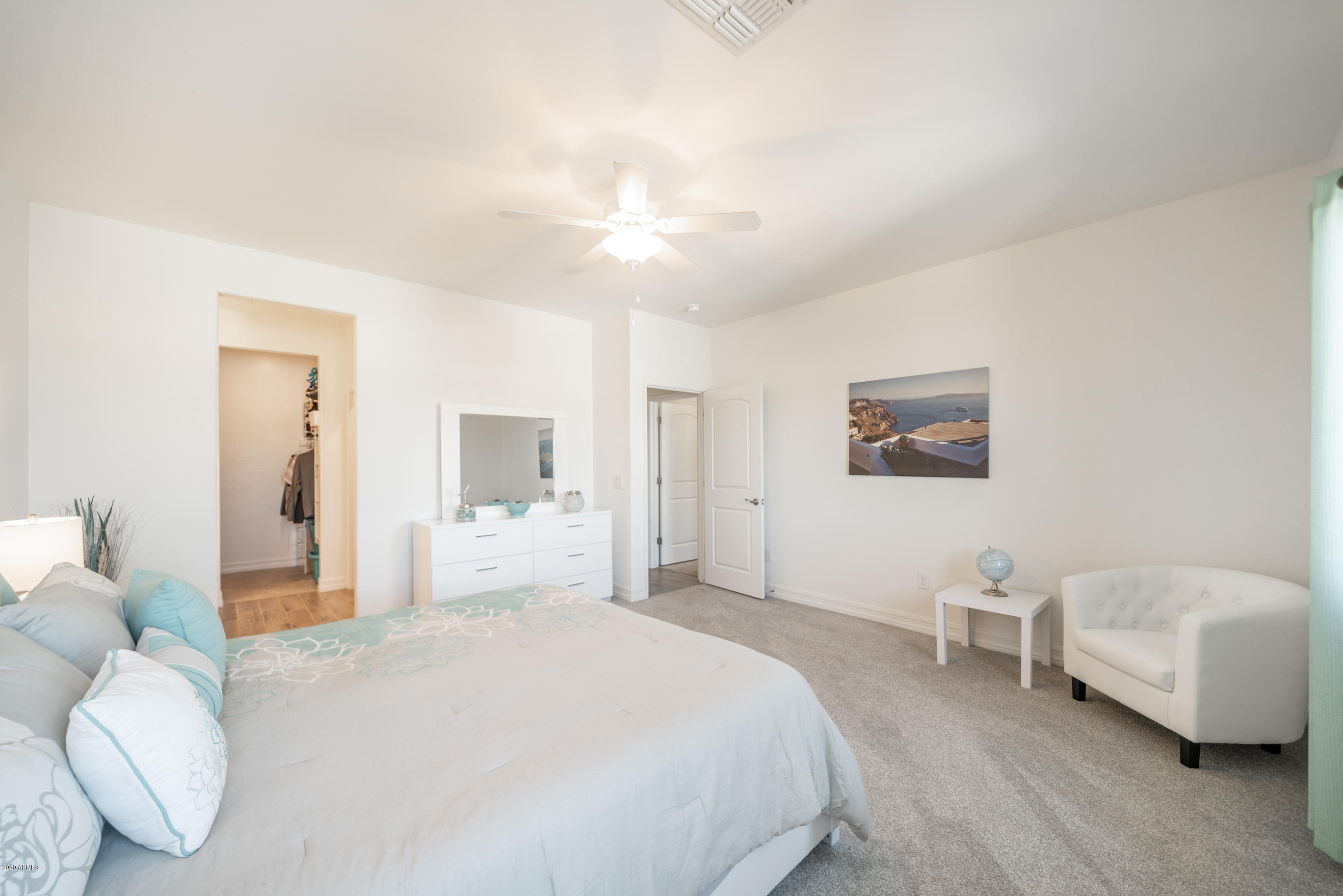 7820 East Baseline Road, Unit 208 Mesa, AZ 85209 - Photo 20 of 29 a spacious bedroom with a bed and a couch