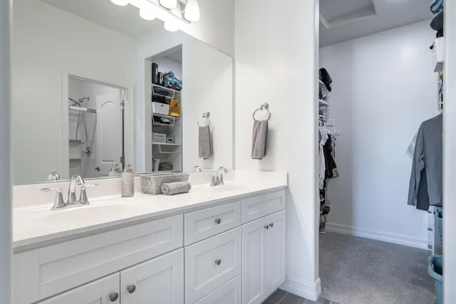 a bathroom with a double vanity sink and a mirror