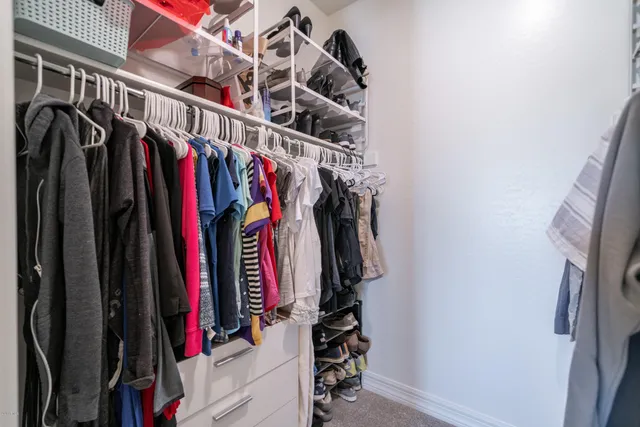 a view of walk in closet with clothes