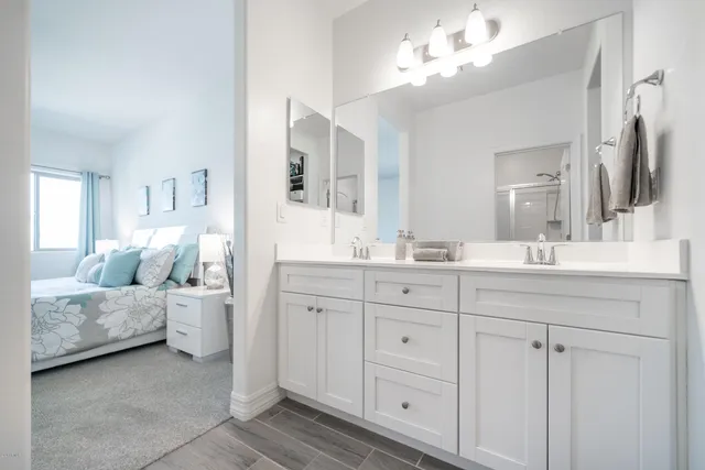 a spacious bathroom with a double vanity sink and a mirror