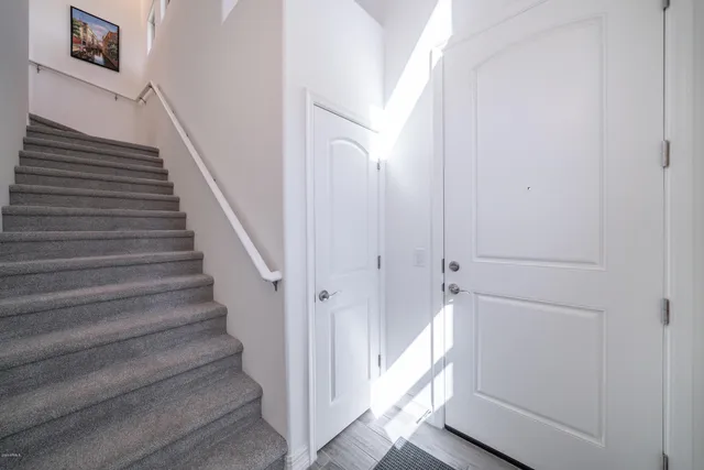 a view of entryway with wooden floor and stairs
