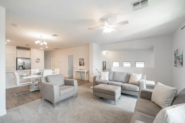 a living room with furniture and a large mirror