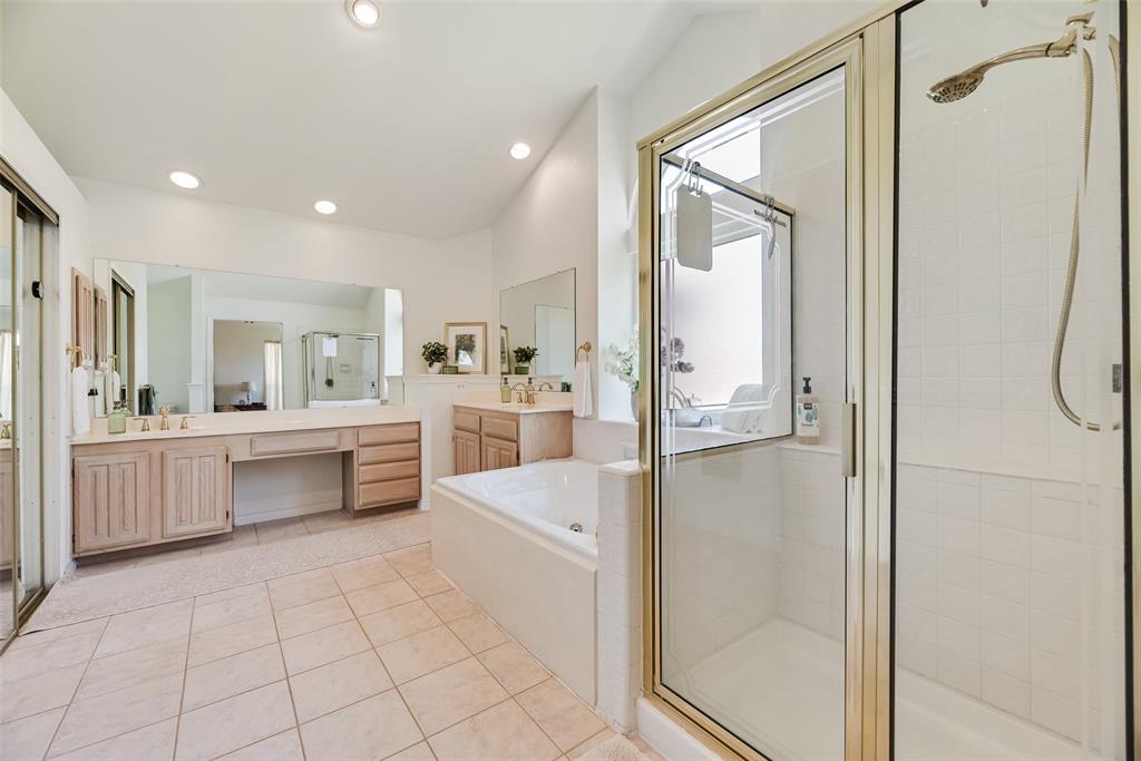 1406 West Peters Colony Road Carrollton, TX 75007 - Photo 10 of 29 a large en suite bathroom with a tub shower and sink