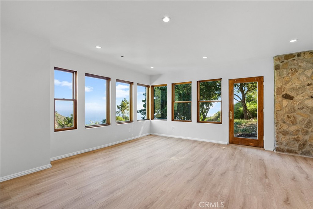 51422 Partington Ridge Road Big Sur, CA 93920 - Photo 13 of 36 a view of an empty room with a window and wooden floor
