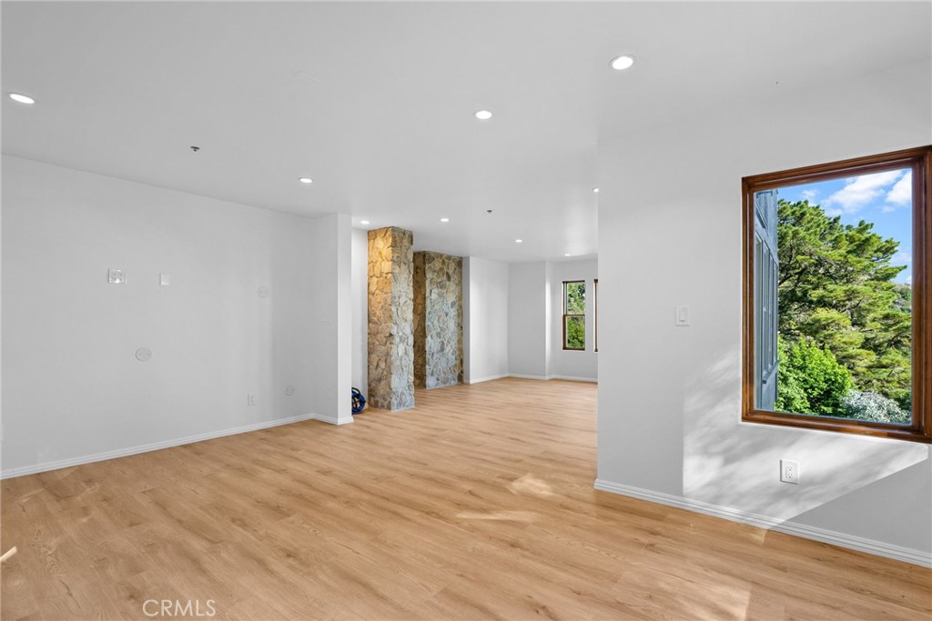 51422 Partington Ridge Road Big Sur, CA 93920 - Photo 18 of 36 a view of an empty room with wooden floor and a window