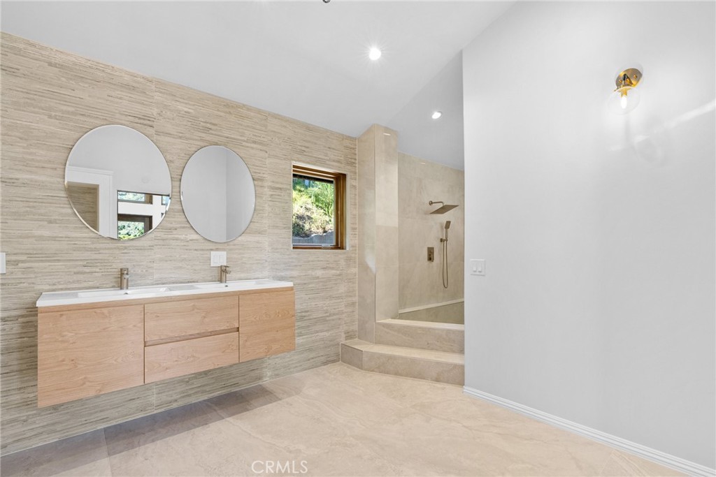 51422 Partington Ridge Road Big Sur, CA 93920 - Photo 22 of 36 a bathroom with a double vanity sink and a mirror