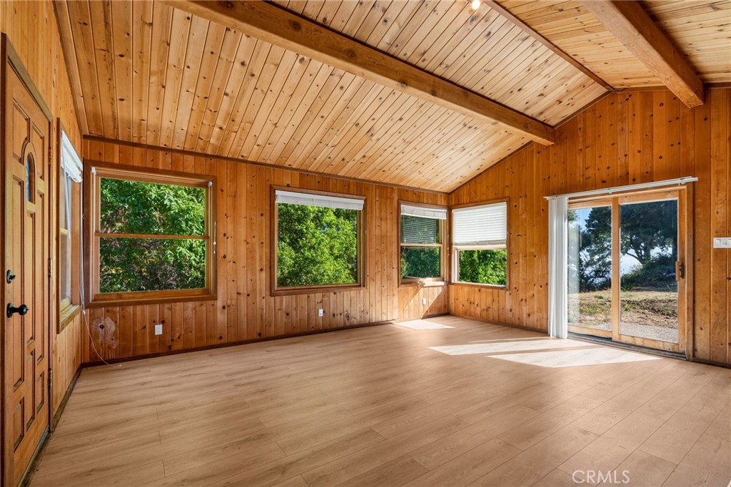 51422 Partington Ridge Road Big Sur, CA 93920 - Photo 31 of 36 an empty room with wooden floor and windows