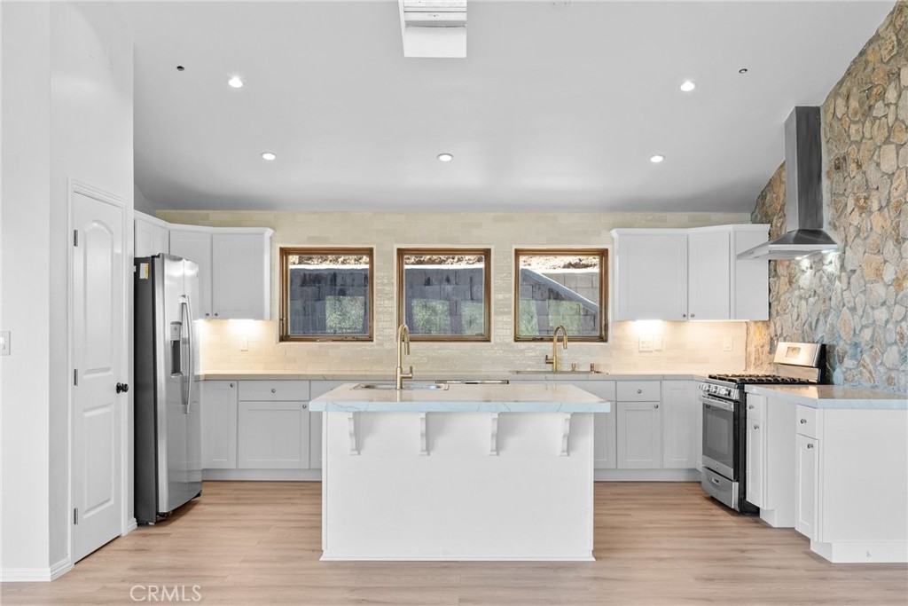 51422 Partington Ridge Road Big Sur, CA 93920 - Photo 4 of 36 a large kitchen with stainless steel appliances granite countertop a stove and a sink