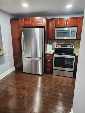 a kitchen with a refrigerator stove and microwave