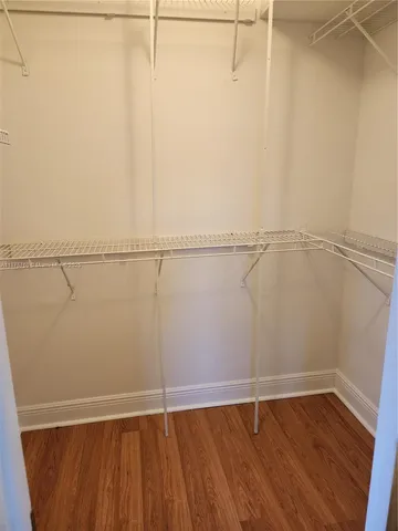 a kitchen with stainless steel appliances kitchen island granite countertop a refrigerator and a stove top oven