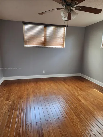 a kitchen with granite countertop a sink and a wooden cabinets