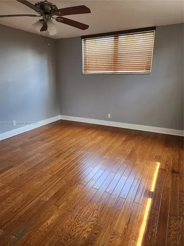 a view of hallway with wooden floor