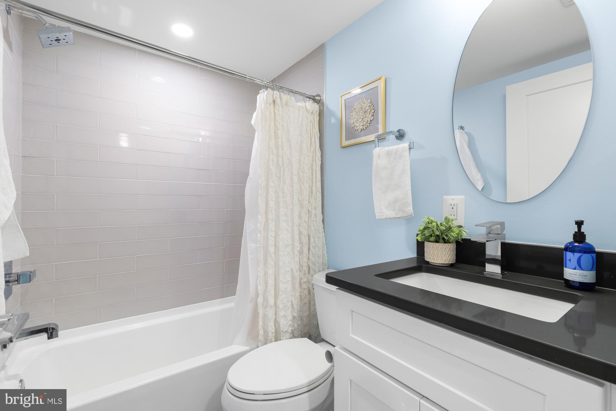 1503 K Street Southeast, Unit C01 Washington, DC 20003 - Photo 13 of 16 a bathroom with a granite countertop sink a toilet and shower