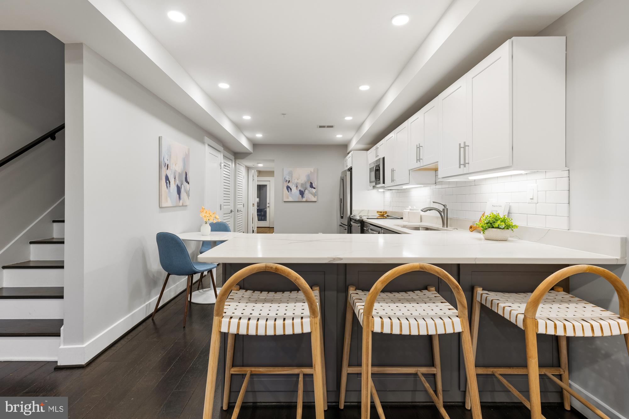 1503 K Street Southeast, Unit C01 Washington, DC 20003 - Photo 5 of 16 a dinning room with stainless steel appliances a dining table and chairs with wooden floor