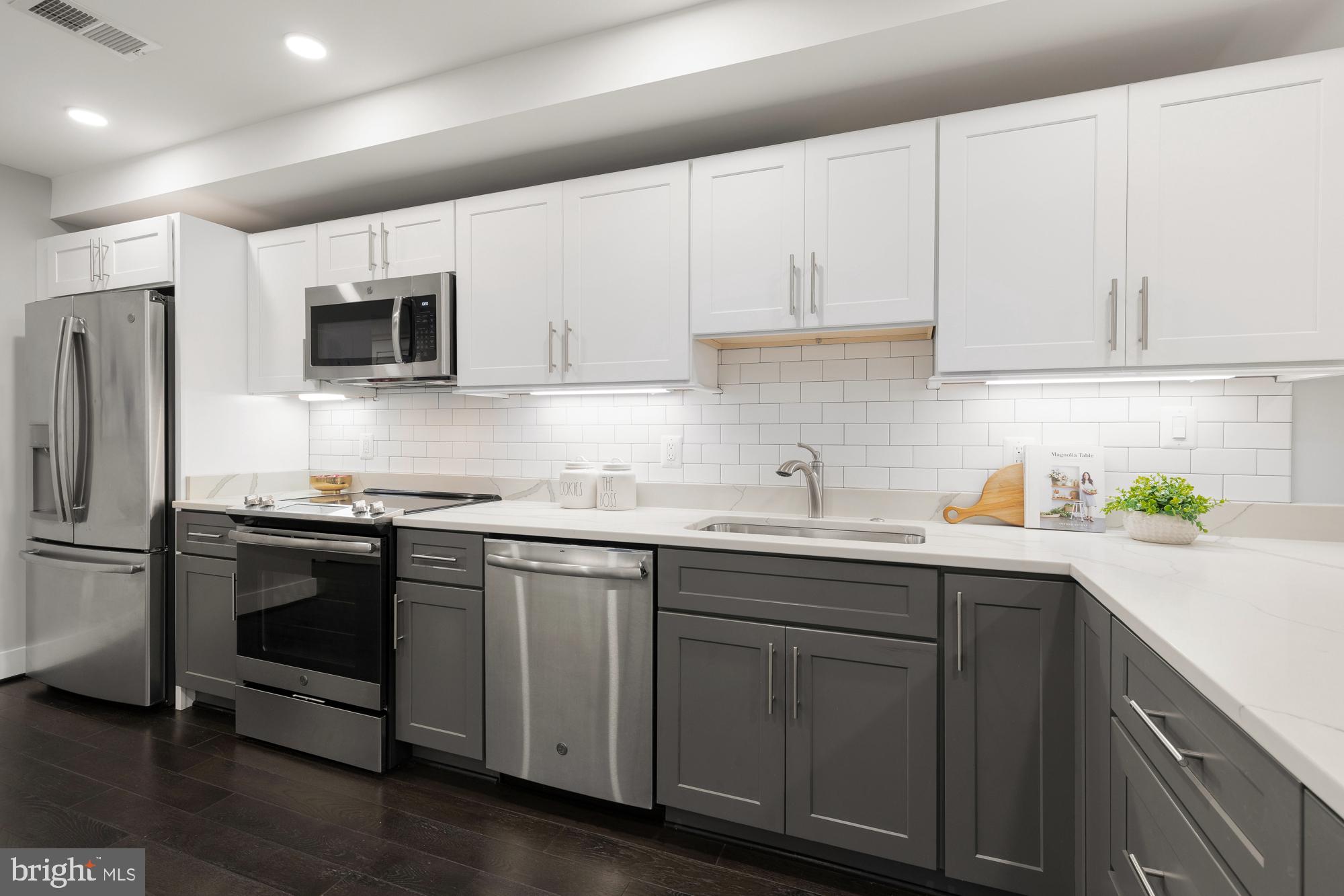 1503 K Street Southeast, Unit C01 Washington, DC 20003 - Photo 6 of 16 a kitchen with stainless steel appliances granite countertop a sink a stove a refrigerator and cabinets