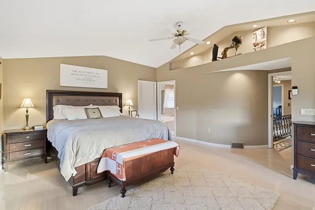 a spacious bedroom with a bed and a dresser