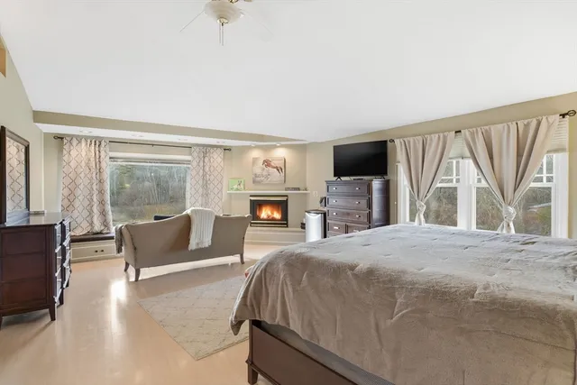 a spacious bedroom with a bed and glass window