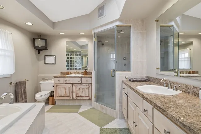 a spacious bathroom with a granite countertop sink mirror and a toilet
