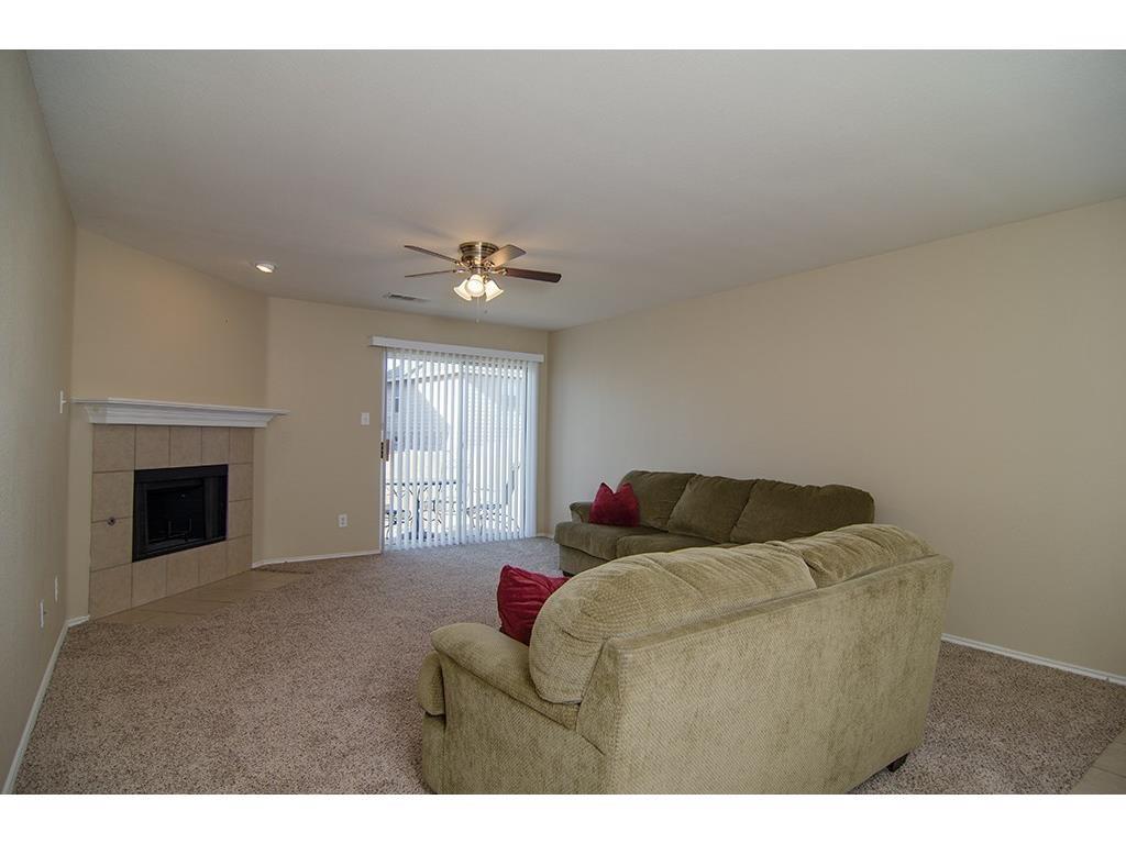 13109 Fieldstone Road Fort Worth, TX 76244 - Photo 13 of 25 Living room with a tiled fireplace, ceiling fan, light colored carpet, and recessed lighting