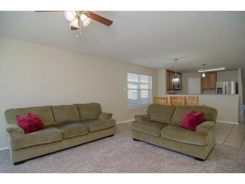 13109 Fieldstone Road Fort Worth, TX 76244 - Photo 16 of 25 Living area with light carpet, a ceiling fan, and light tile patterned flooring