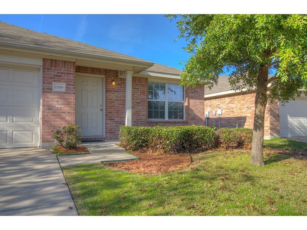 13109 Fieldstone Road Fort Worth, TX 76244 - Photo 2 of 25 View of exterior entry with a garage, brick siding, and a lawn