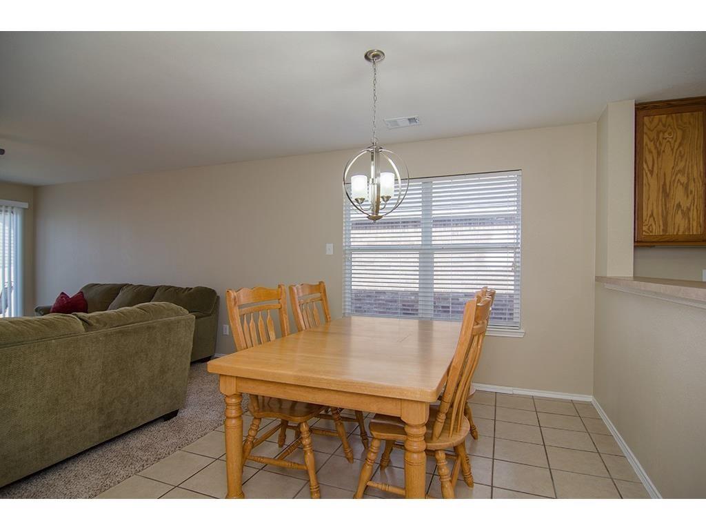 13109 Fieldstone Road Fort Worth, TX 76244 - Photo 6 of 25 Dining area featuring suspended lighting and light tile patterned flooring