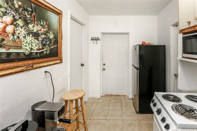 a kitchen with stainless steel appliances granite countertop a refrigerator and a stove
