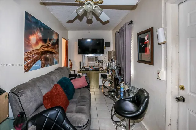 a living room with furniture or chandelier and a flat screen tv