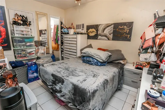 a bedroom with a bed and dresser