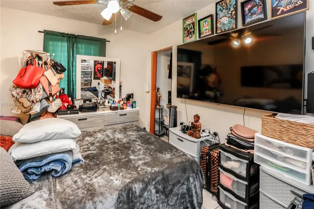a bedroom with furniture and a flat screen tv
