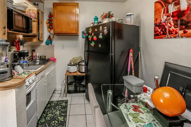 a kitchen with stainless steel appliances a chimney a sink and cabinets