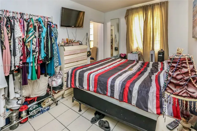 a bed room with a bed and a television