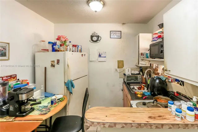a bedroom with a workspace and a flat screen tv