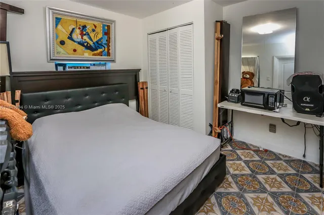 a bed room with a bed and a television