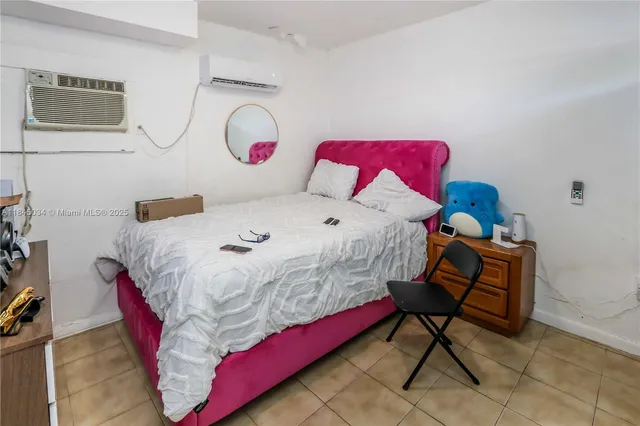 a bedroom with a bed and dresser