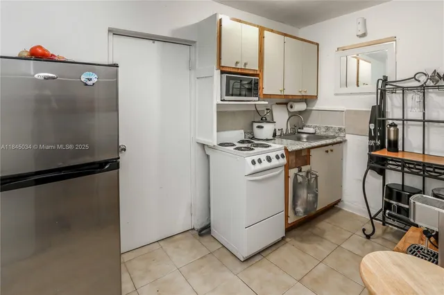 a kitchen with a stove a refrigerator and a sink